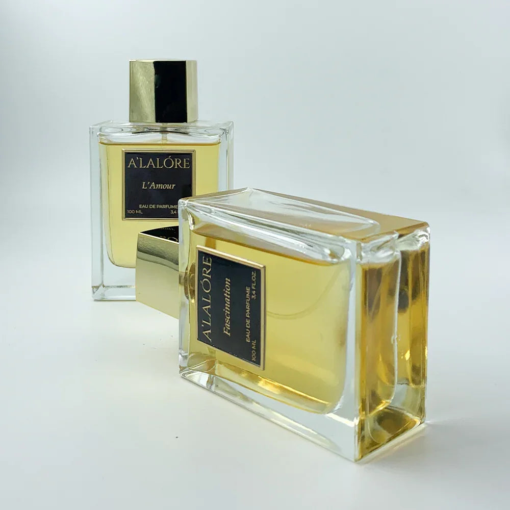 A'LALÓRE markalı iki şişe kadın parfüm altın kapaklı ve şeffaf cam tasarımında